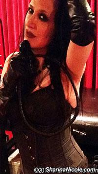 Femdom Mistress Sharina Nicole with her single tail whip in her studio located in Minneapolis, Minnesota